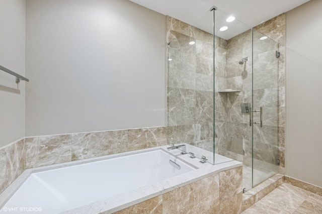 full bathroom with recessed lighting, a garden tub, and a shower stall