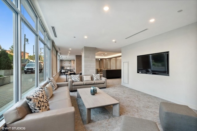 carpeted living room with recessed lighting, visible vents, baseboards, and ornate columns