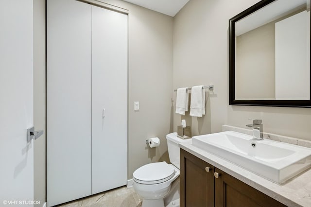 bathroom featuring toilet and vanity