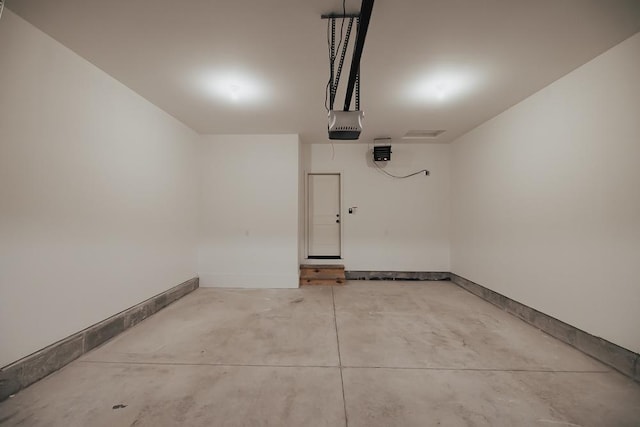 garage with a garage door opener and baseboards