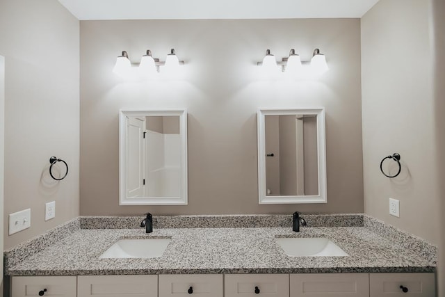 bathroom featuring double vanity and a sink