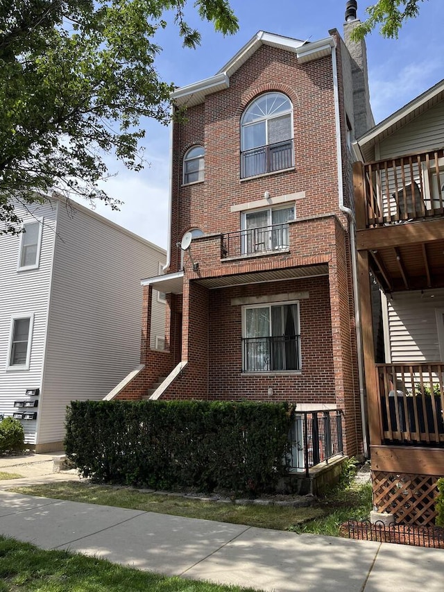 exterior space with brick siding and a chimney