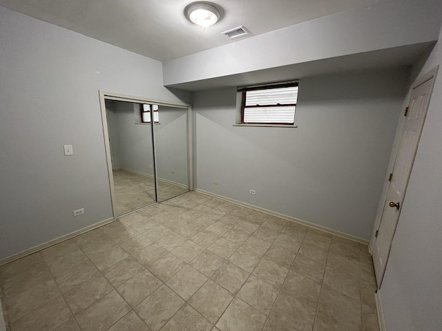 unfurnished bedroom featuring a closet, visible vents, and baseboards