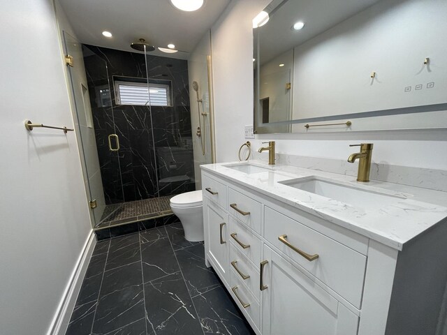 full bath with toilet, marble finish floor, a marble finish shower, and a sink