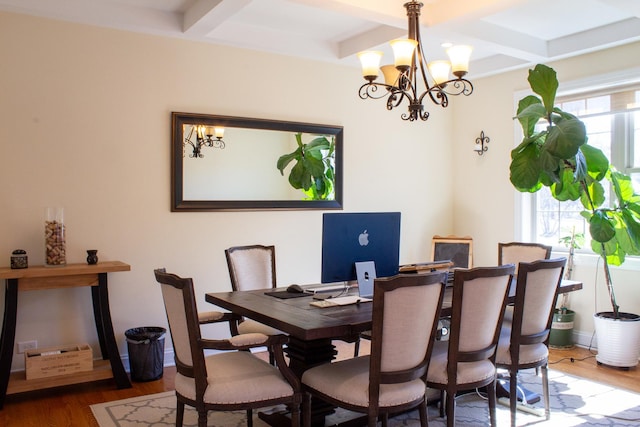 dining room featuring a chandelier, coffered ceiling, a wealth of natural light, and wood finished floors