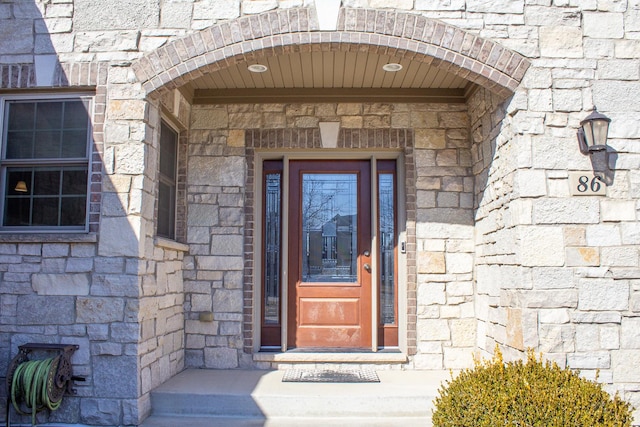 property entrance featuring stone siding