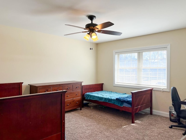 bedroom with a ceiling fan, light colored carpet, and baseboards