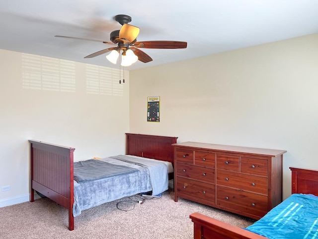 bedroom with light carpet, baseboards, and a ceiling fan