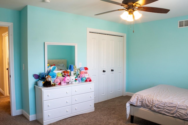 carpeted bedroom featuring a closet, visible vents, and a ceiling fan