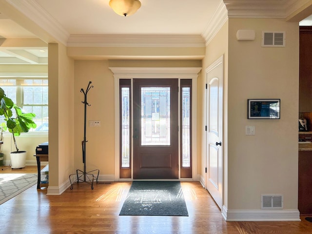 foyer entrance with visible vents, light wood-style flooring, and baseboards