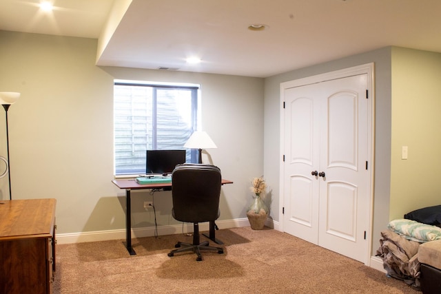 carpeted office space featuring visible vents and baseboards