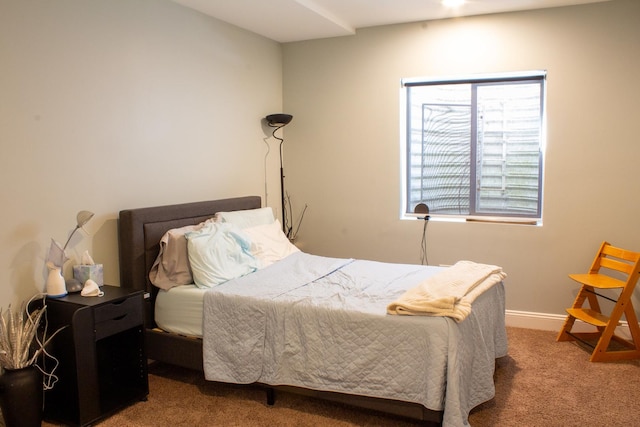bedroom featuring baseboards and carpet