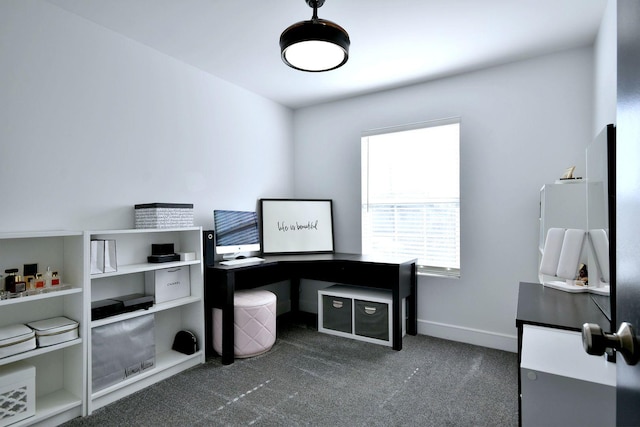 office space featuring dark carpet and baseboards