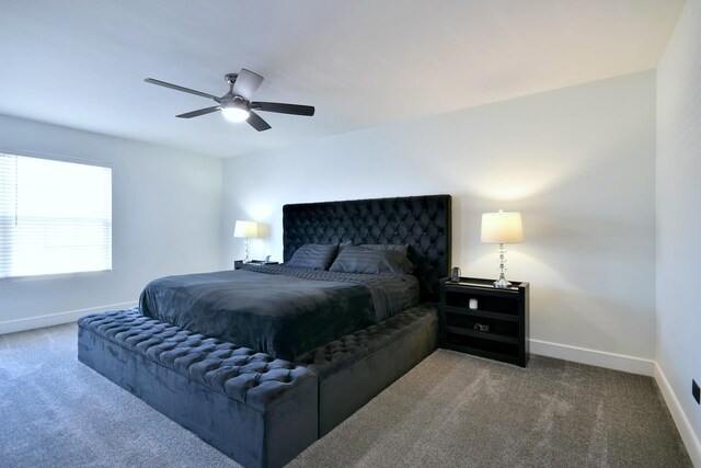 bedroom with a ceiling fan, baseboards, and carpet floors