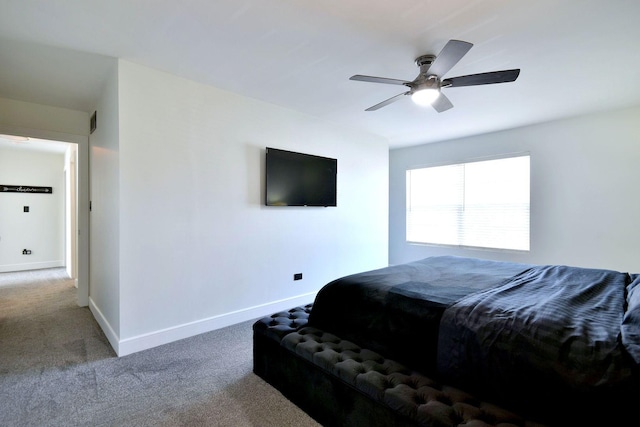 carpeted bedroom with visible vents, a ceiling fan, and baseboards