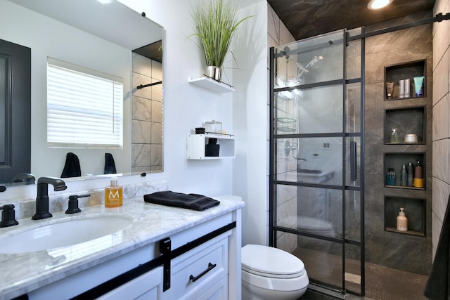 bathroom featuring a stall shower, toilet, and vanity