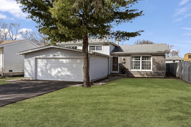 view of front of property with brick siding, a front lawn, fence, aphalt driveway, and an attached garage