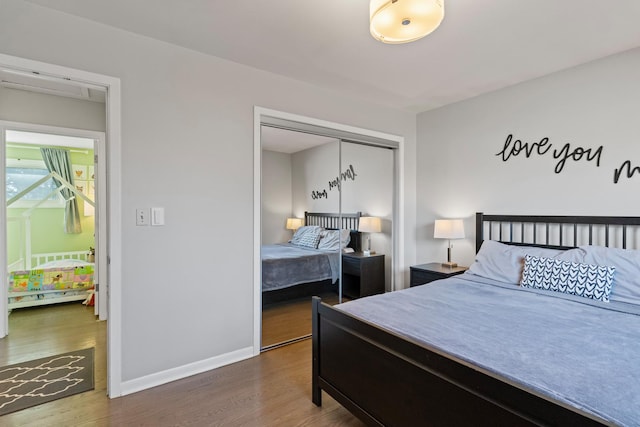 bedroom with a closet, baseboards, and wood finished floors