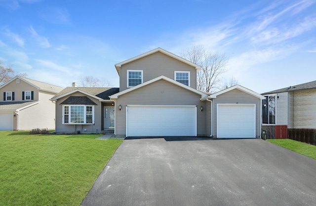 traditional-style house with a front yard, fence, a garage, and driveway