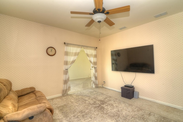 unfurnished living room with visible vents, ceiling fan, wallpapered walls, and carpet