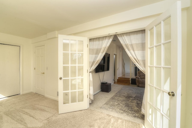 additional living space featuring french doors, baseboards, and carpet floors