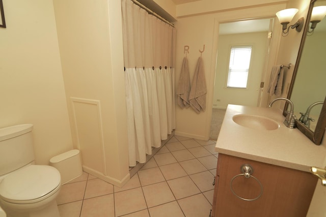 bathroom with curtained shower, toilet, vanity, and tile patterned flooring