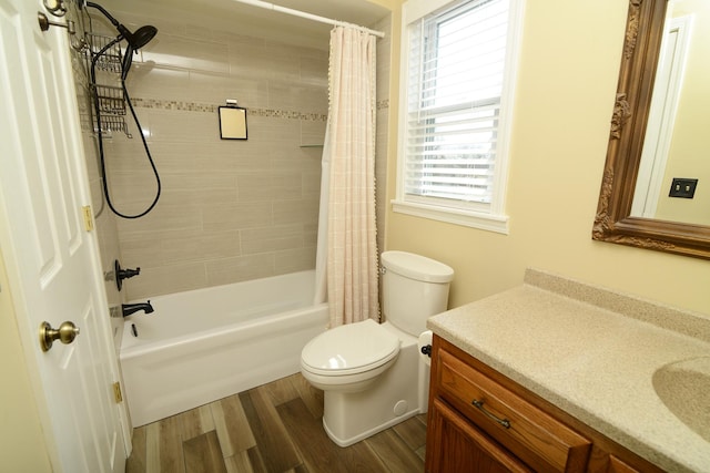 full bath with shower / tub combo with curtain, wood finished floors, vanity, and toilet