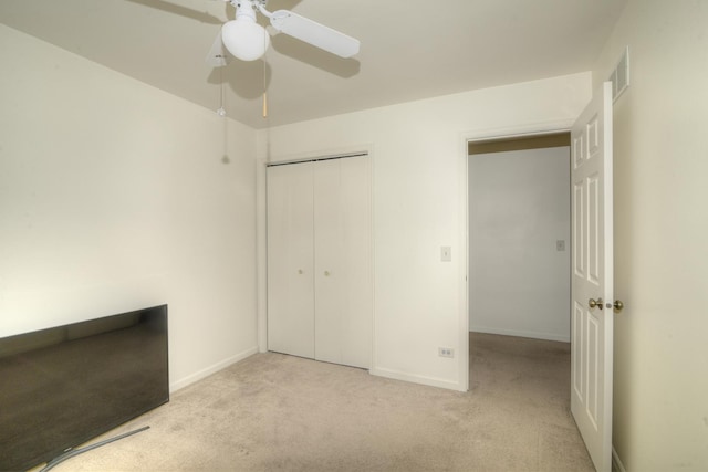 unfurnished bedroom with visible vents, a closet, carpet, baseboards, and ceiling fan