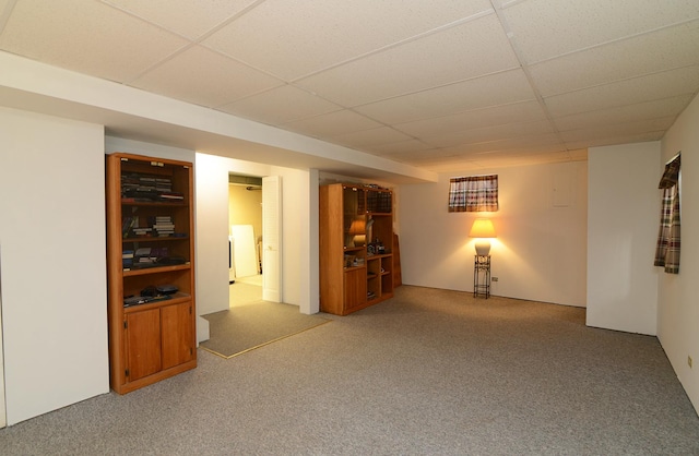 spare room featuring a paneled ceiling and carpet floors