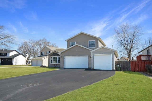 view of front of property featuring aphalt driveway, a garage, a front lawn, and fence