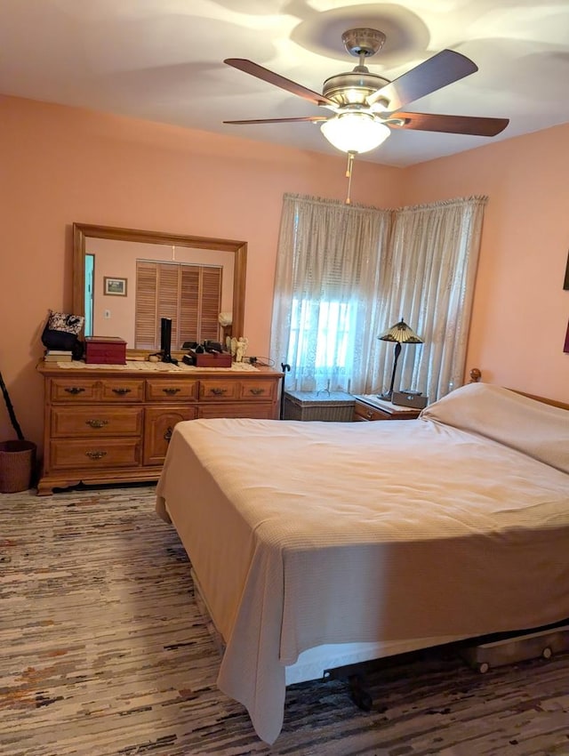 bedroom featuring a closet, ceiling fan, and wood finished floors