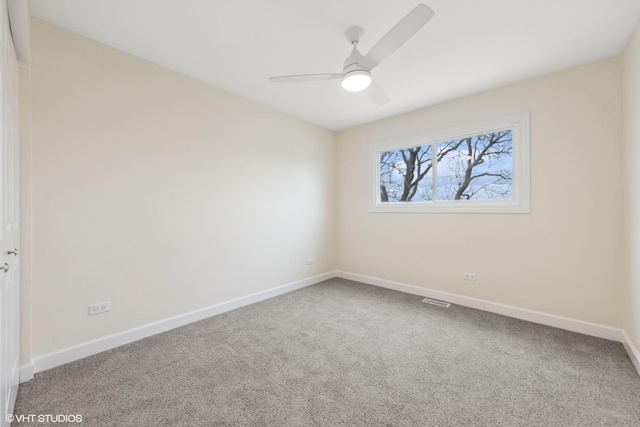 unfurnished room with carpet flooring, visible vents, baseboards, and a ceiling fan