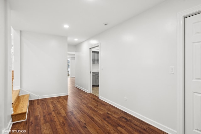 hallway with dark wood-style floors, stairway, recessed lighting, and baseboards