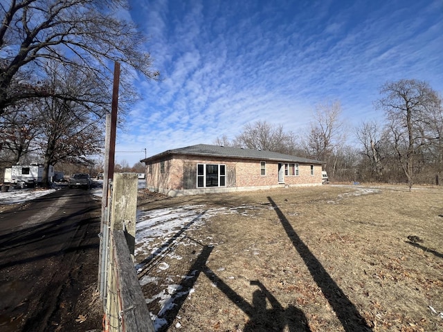 rear view of property with brick siding