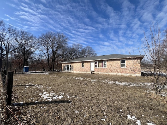 back of house featuring brick siding