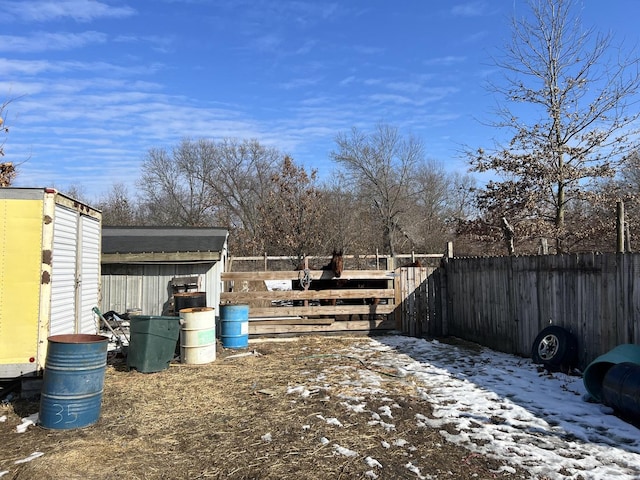 view of yard featuring an outdoor structure and fence