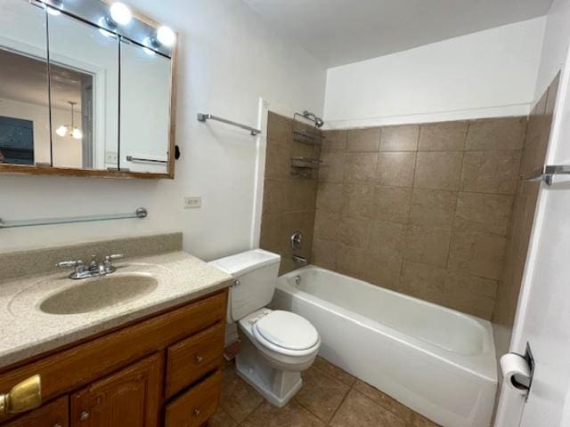 bathroom with tile patterned flooring, toilet, vanity, and shower / bathtub combination