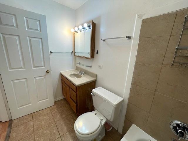 bathroom featuring tile patterned floors, toilet, and vanity