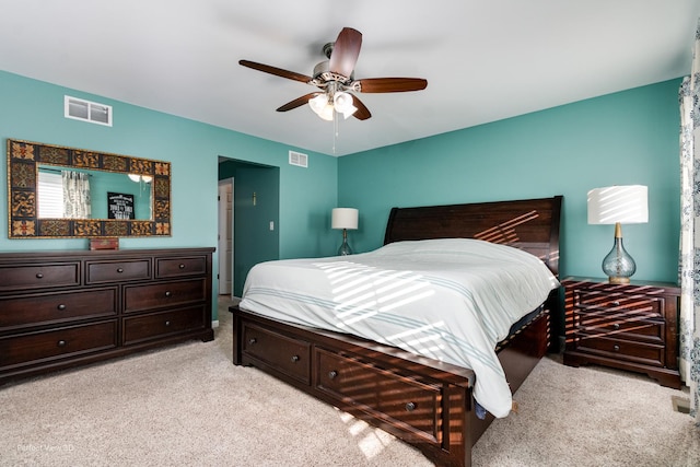 bedroom with light carpet, visible vents, and a ceiling fan