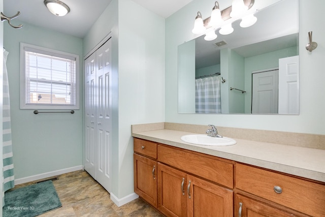 bathroom with visible vents, baseboards, a closet, and vanity