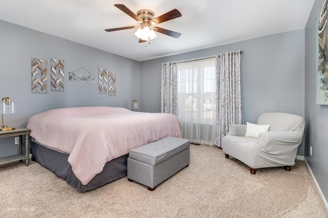 carpeted bedroom with baseboards and ceiling fan