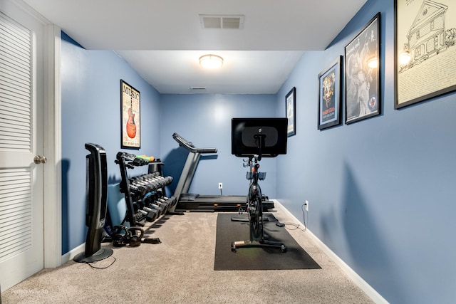 exercise area with visible vents, baseboards, and carpet