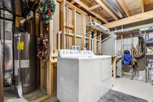 unfinished below grade area featuring water heater and washing machine and clothes dryer