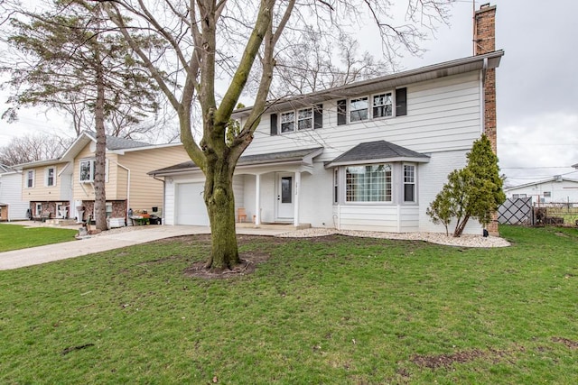 view of front facade featuring a front yard, driveway, a chimney, a garage, and brick siding