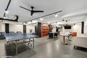 recreation room featuring speckled floor and ceiling fan