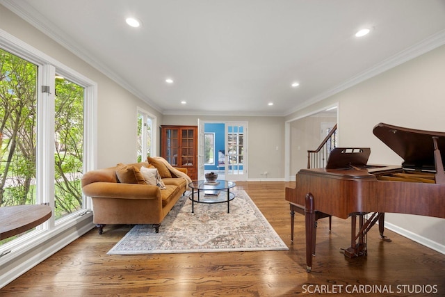 living area with baseboards, recessed lighting, wood finished floors, and ornamental molding