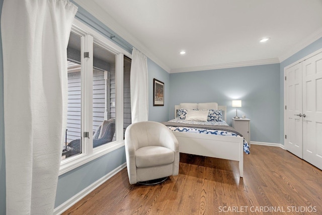 bedroom featuring crown molding, baseboards, recessed lighting, and wood finished floors