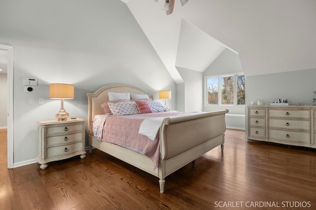 bedroom with baseboards, vaulted ceiling, and wood finished floors
