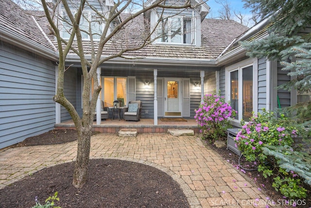 doorway to property featuring covered porch