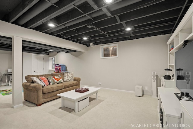 living area with baseboards and light colored carpet